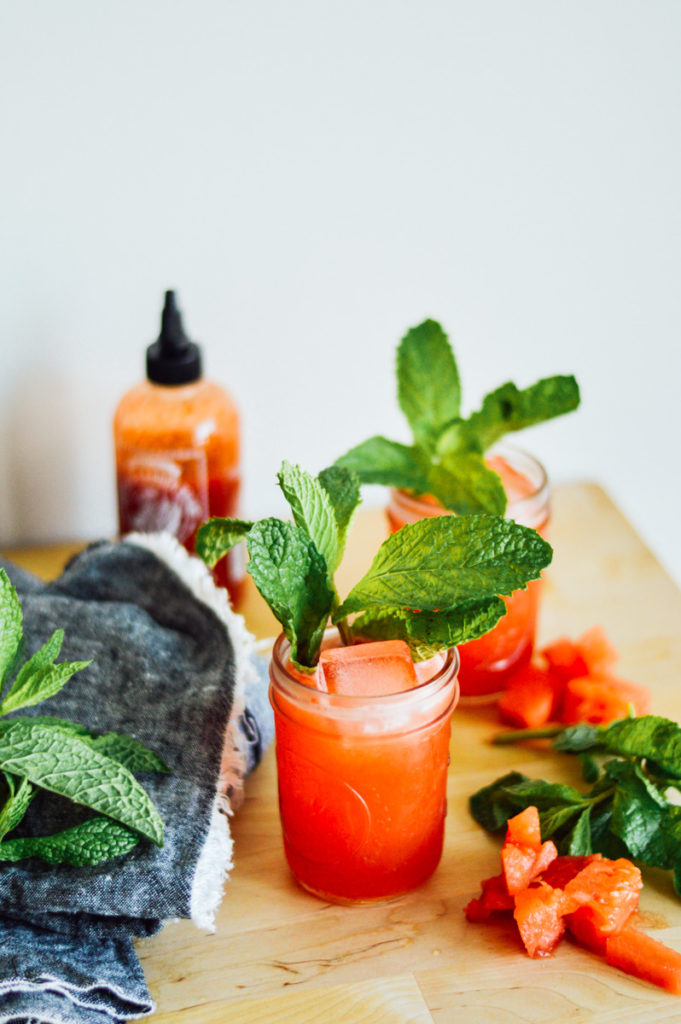 A sweet and spicy Sriracha Watermelon Cooler that's perfect for those warm summer days. Enjoy this cocktail outdoors, for sure! / bygabriella.co