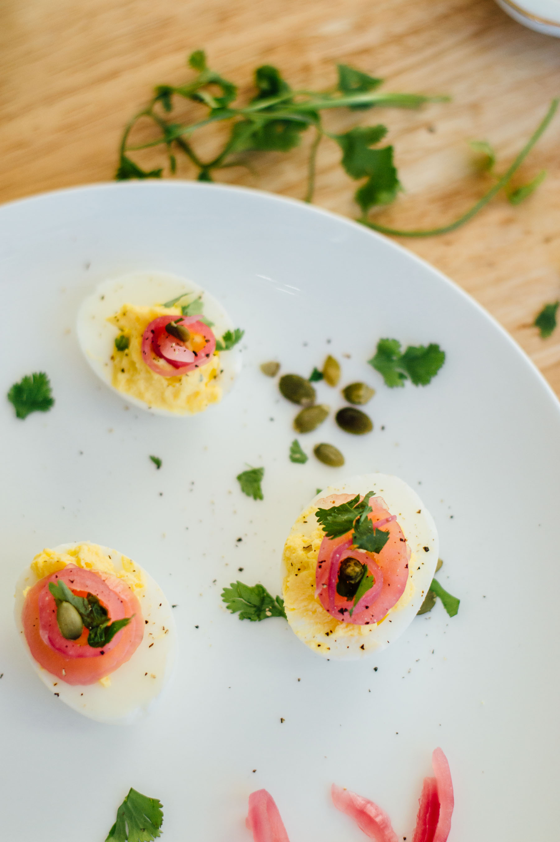 Make your own Mexican deviled eggs right at home with pickled red onions, pepitas, and fresh cilantro | bygabriella.co