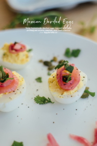 A tasty Mexican deviled eggs recipe with cilantro, pepitas, and pickled red onions | bygabriella.co