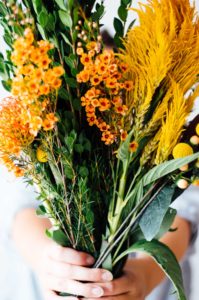 A stunning autumn-inspired floral arrangement with lush greens, bright yellows, and rich oranges | bygabriella.co