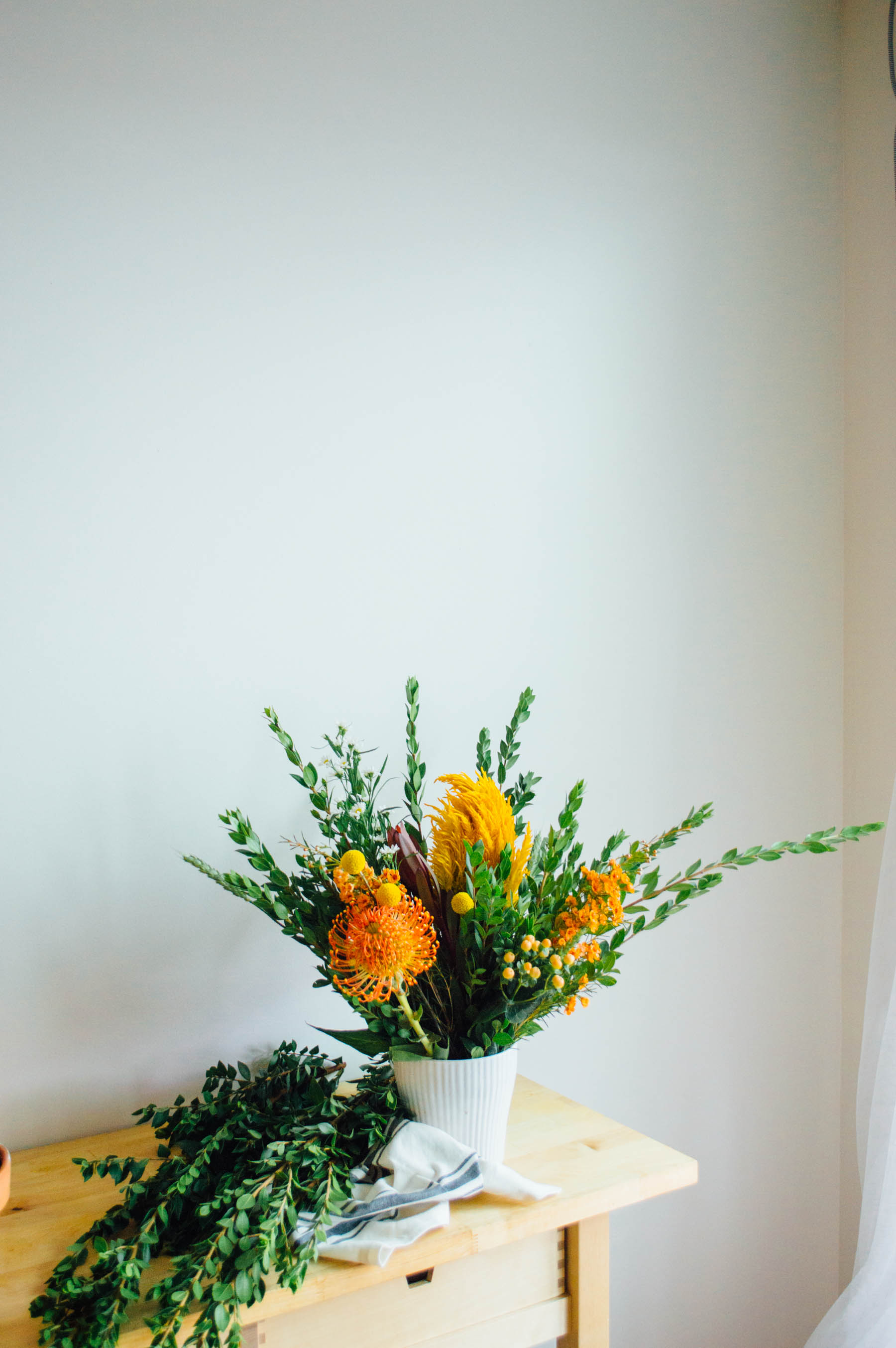 An autumn-inspired fall arrangements filled with lush greens and gorgeous yellow flowers | bygabriella.co