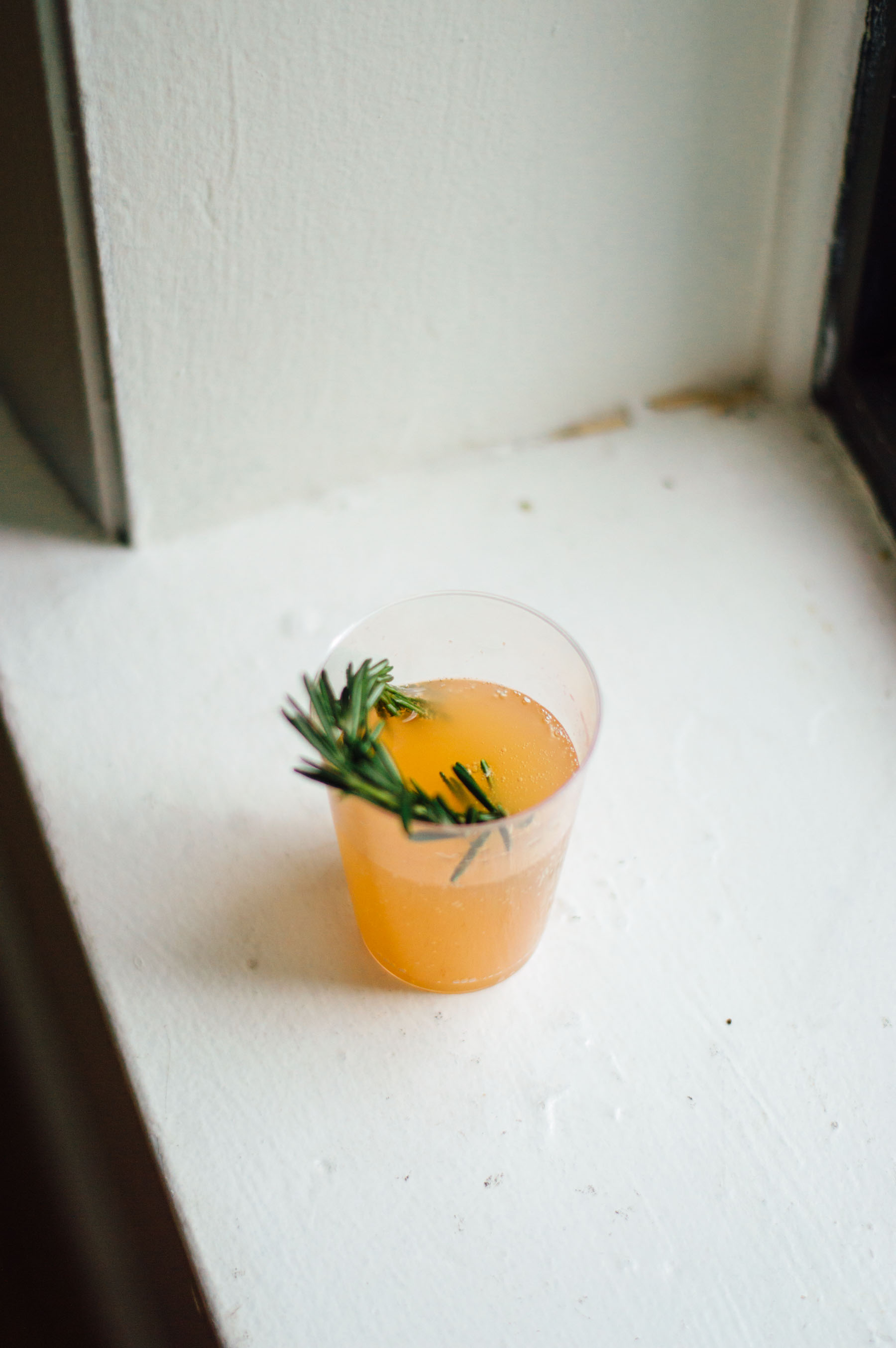 Rosemary Grapefruit Fizz recipe with champagne (always say yes to bubbly!), fresh rosemary, grapefruit juice, elderflower lemonade, and Pamplemousse | bygabriella.co
