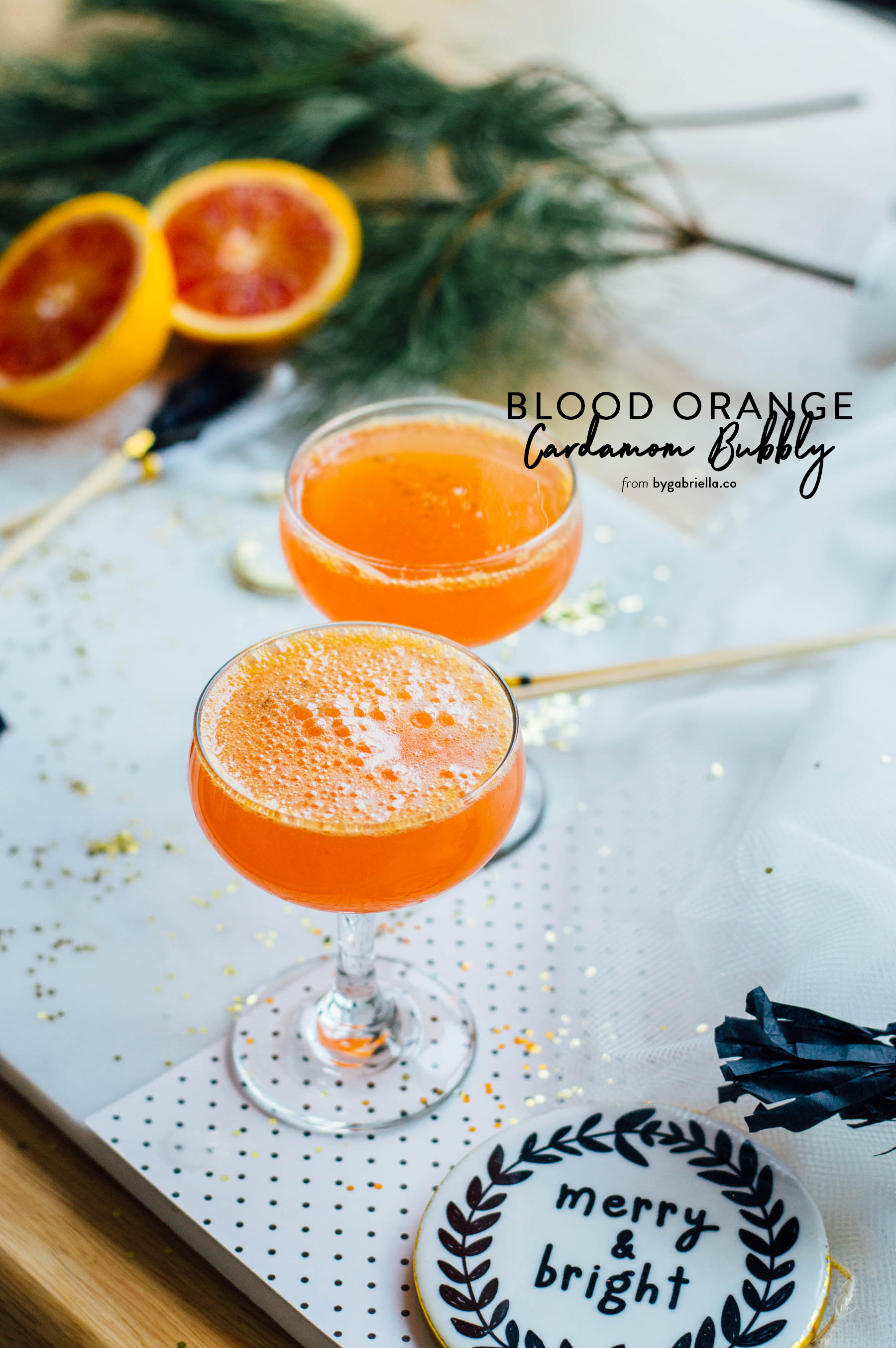 A tasty Blood Orange Cardamom Bubbly cocktail recipe with cava, fresh blood oranges, and a homemade vanilla-cardamom simple syrup. | full recipe at bygabriella.co