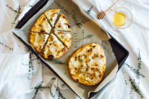 Pear & Honey Whipped Goat Cheese Naan Pizza recipe with fresh thyme and a honey drizzle. | bygabriella.co