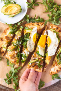 Breakfast naan pizza recipe with caramelized onions, jalapeño sausage, and queso fresco - so much yum! | bygabriella.co