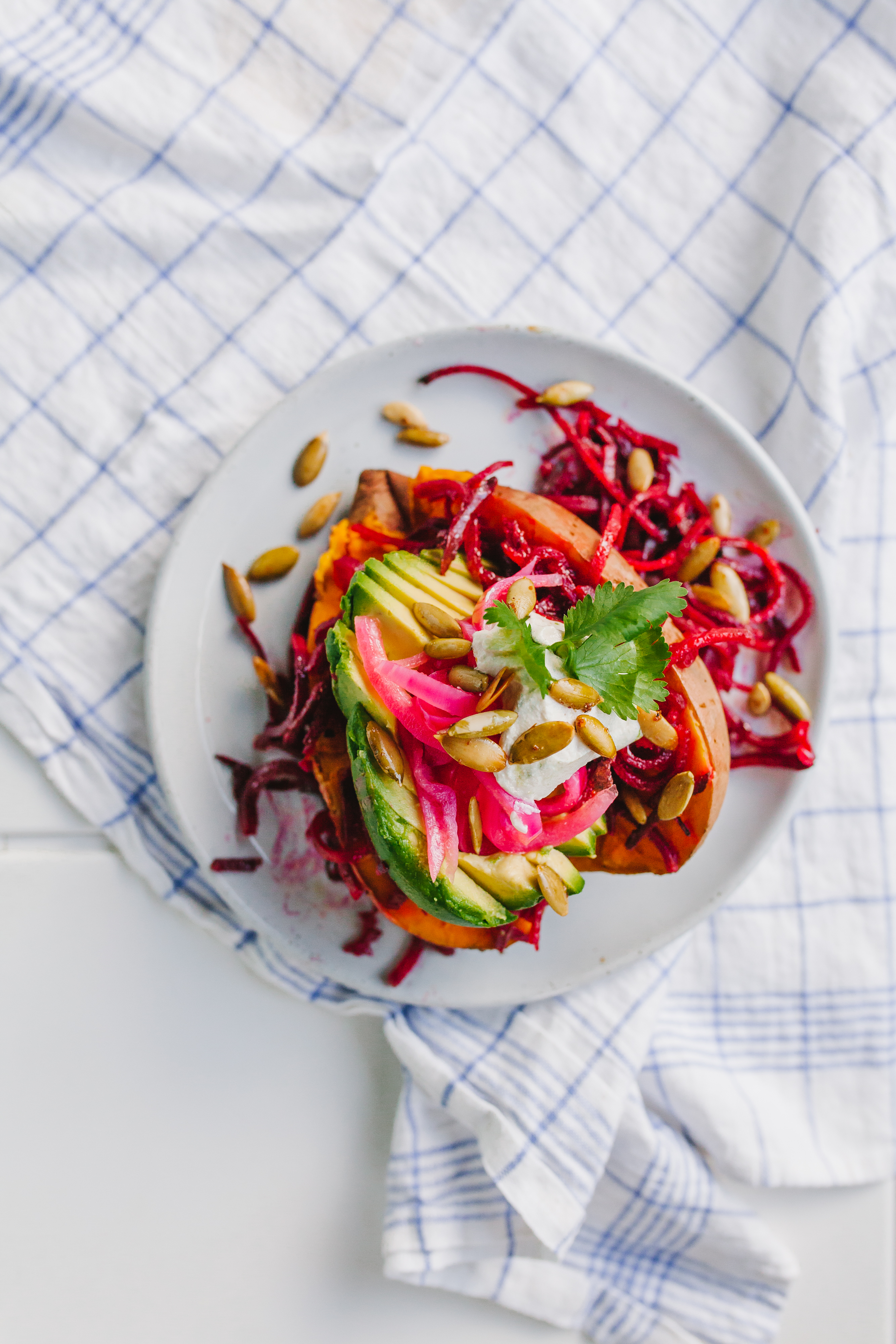 Stuffed Sweet Potatoes with roasted pepitas, avo, beet spirals, and more - so much yum! | bygabriella.co