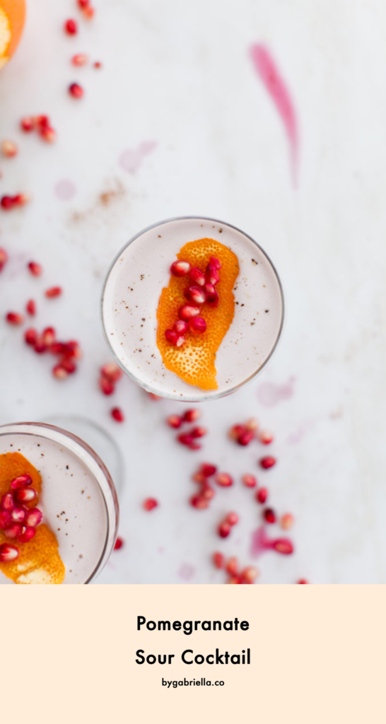 Pomegranate Sour Cocktail with Spiced Orange Syrup - so perfect for fall and winter. A fruity holiday cocktail that's sure to please your guests | bygabriella.co @gabivalladares