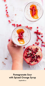 Pomegranate Sour Cocktail with Spiced Orange Syrup - so perfect for fall and winter. A fruity holiday cocktail that's sure to please your guests | bygabriella.co @gabivalladares