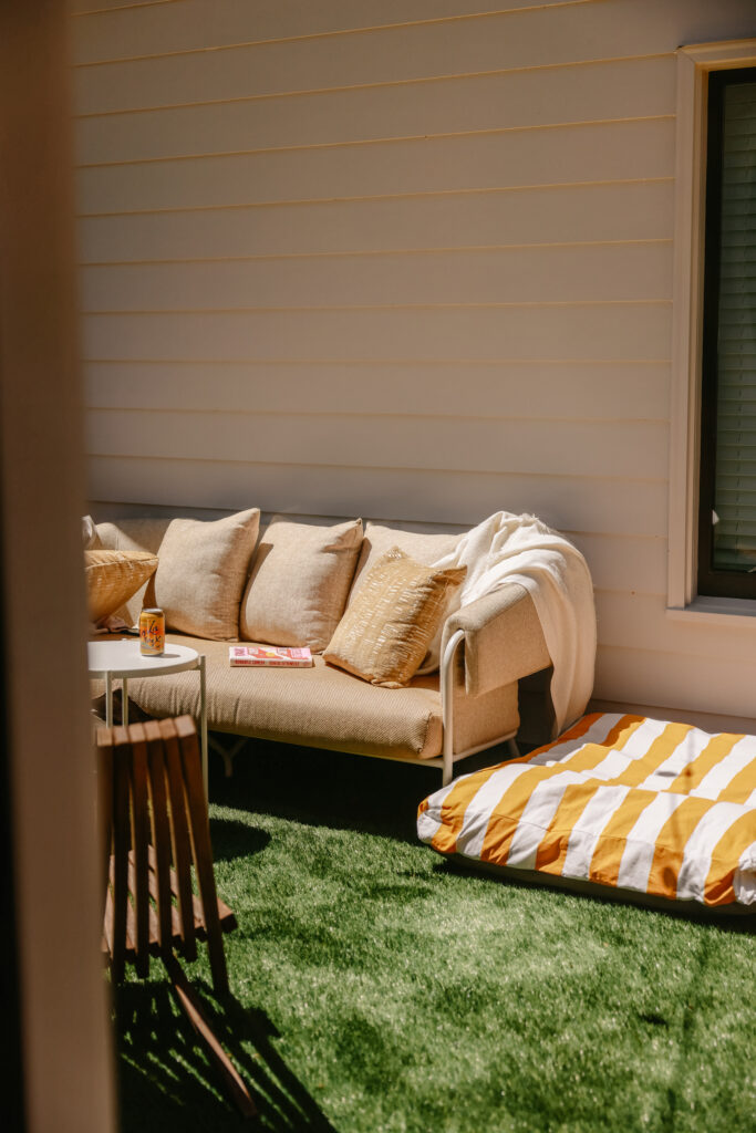 A small outdoor space in the sun featuring the campana sofa from Crate and Barrel